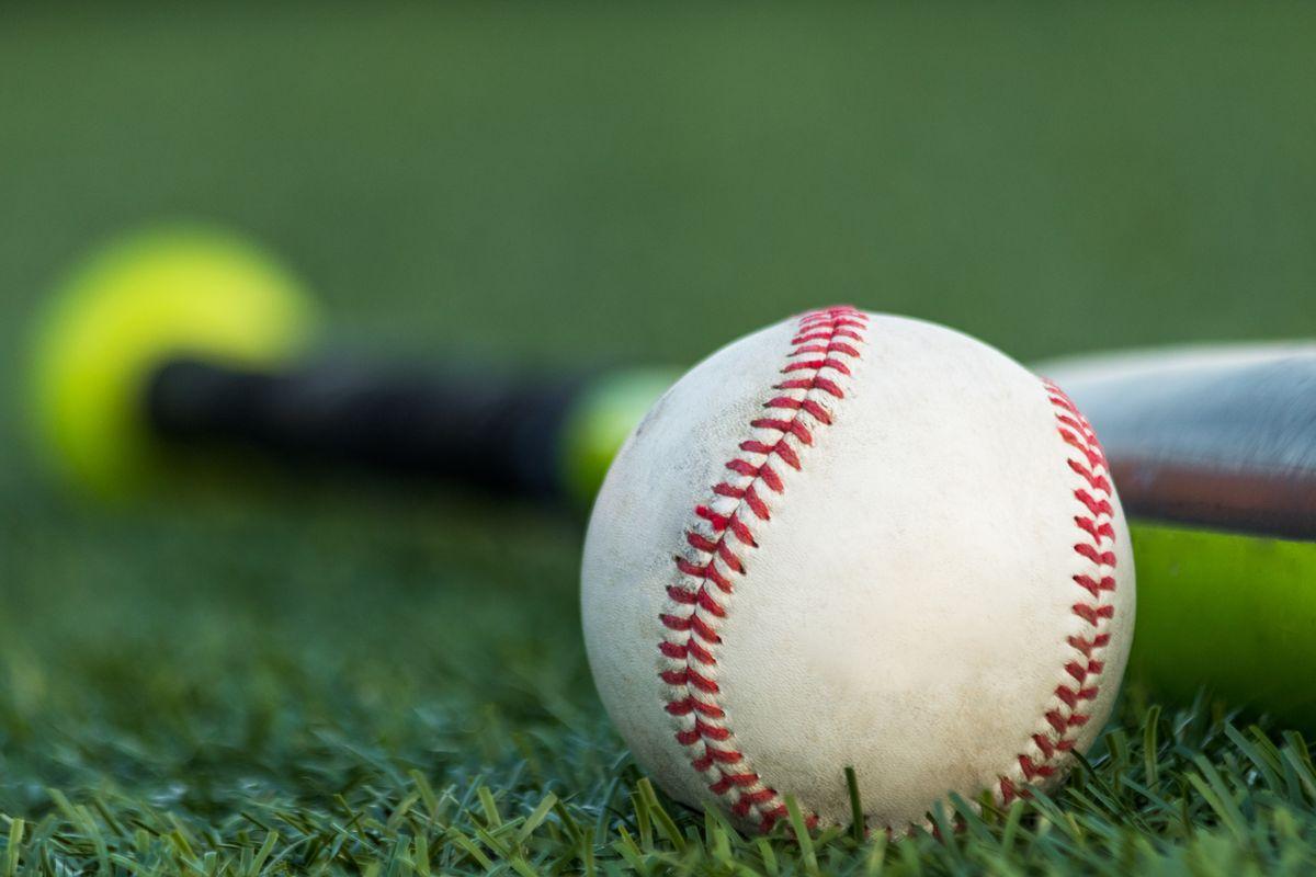 Close up of a baseball and a baseball bat